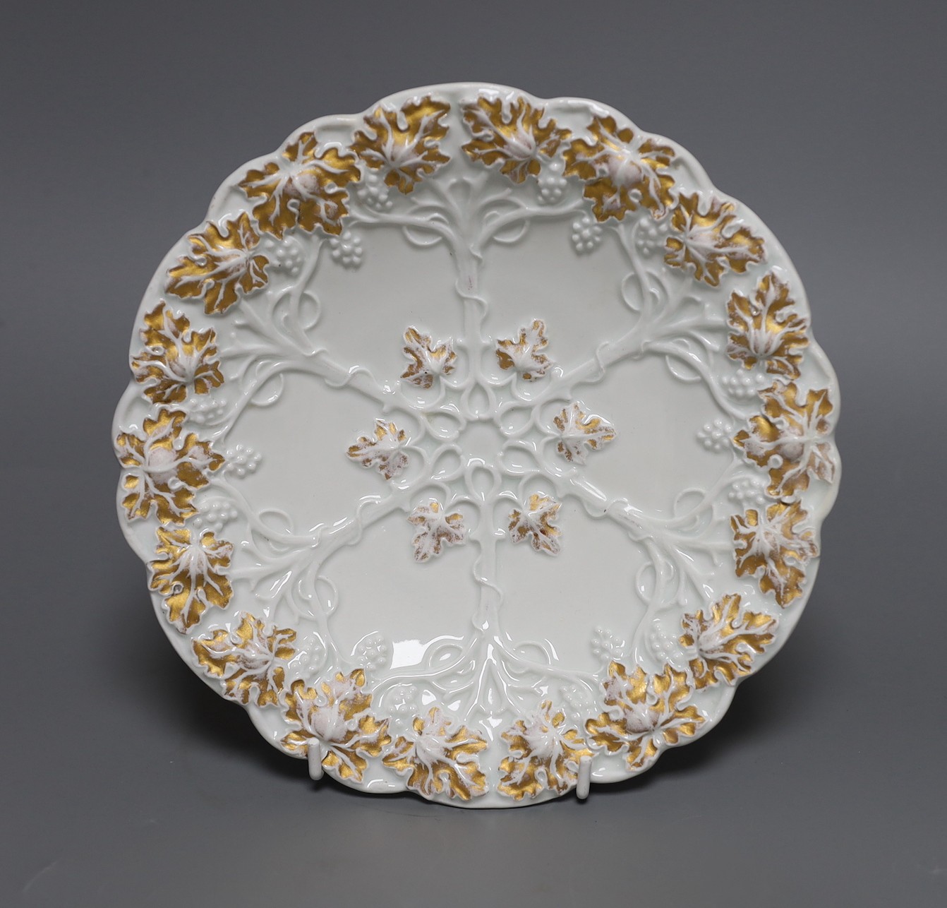 A Mesissen gilt decorated moulded dish, 21.5 cms diameter